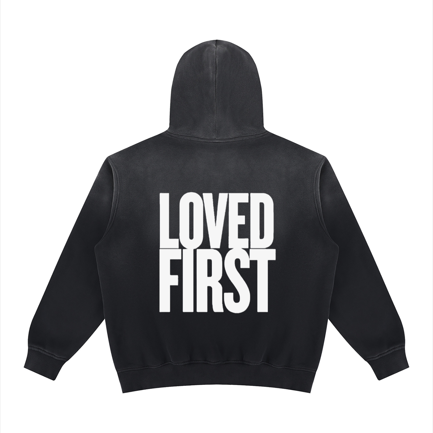 A black hooded sweatshirt shown from the back, featuring the words 'LOVED FIRST' printed in large, bold white block letters across the center.