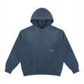 A Washed Blue blue pullover hoodie with a small white printed 'LovedFirst' logo on the left chest, displayed on a clean white background.