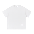 A white short-sleeve crewneck t-shirt with a small black 'Lovedfirst' logo printed on the lower right front, displayed flat against a solid white background.