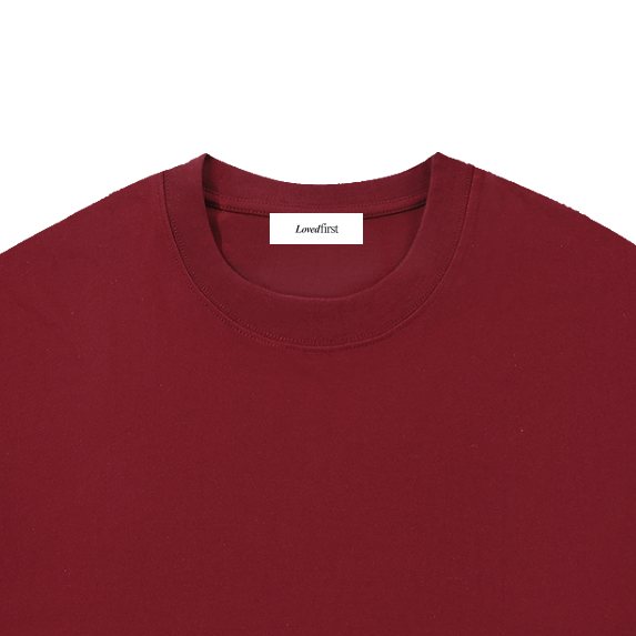 A dark red crewneck t-shirt with a small white 'Loudfirst' logo printed on the bottom right, displayed flat against a solid white background.